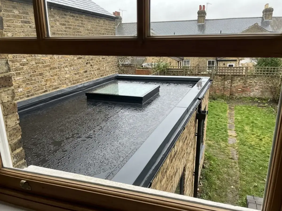 New rubber flat roof with a rooflight on a rear extension, seen from an upstairs window