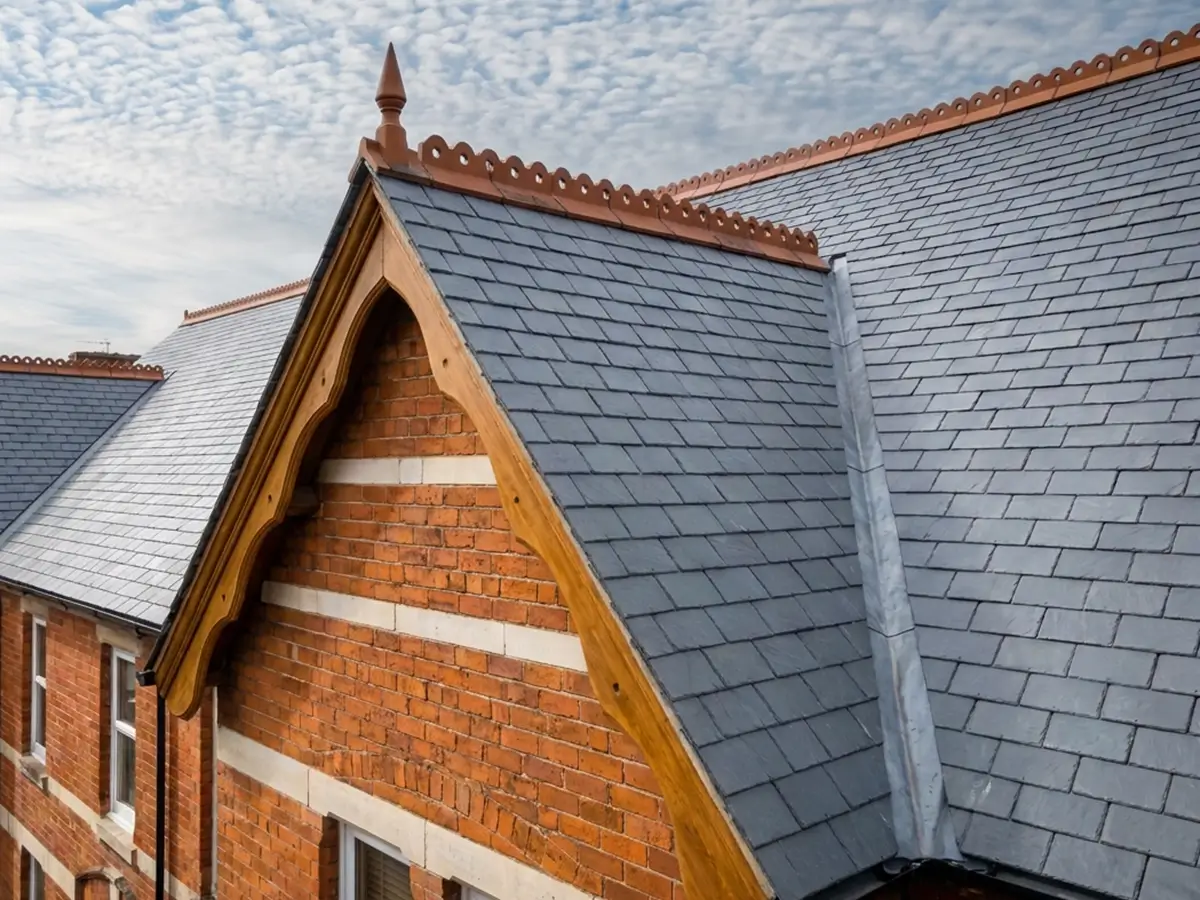 New slate roof with terracotta ridge tiles and a lead valley